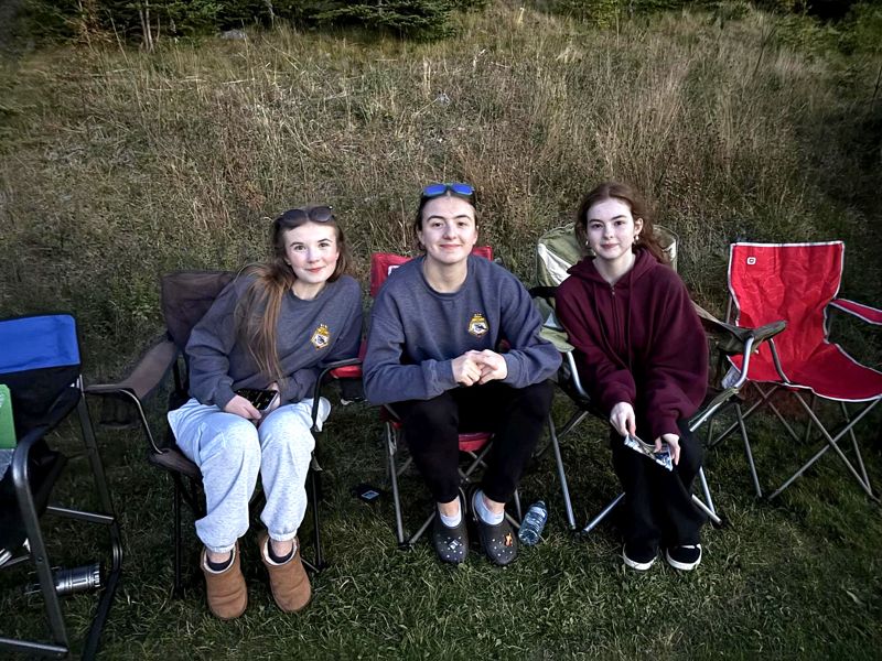 Three cadets in camp chairs