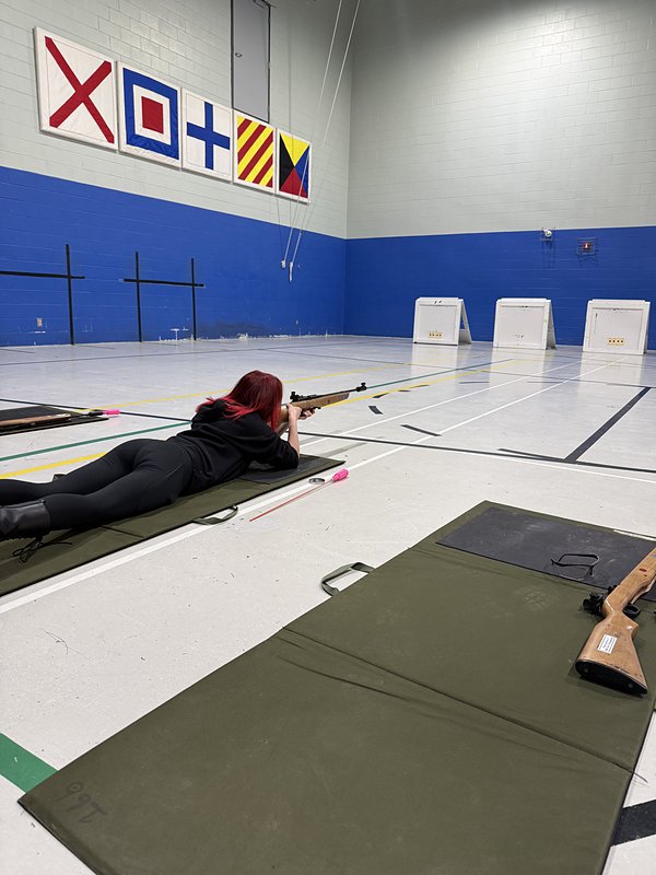 A cadet lining up a shot on the range